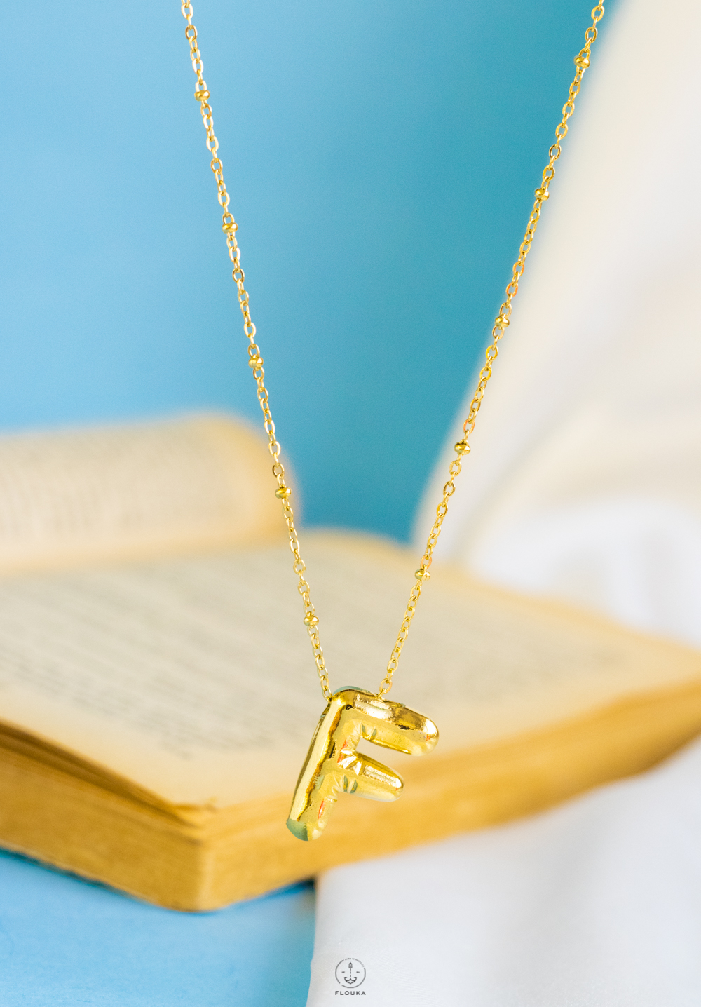 1724238352_IMG_1320.jpg gold helium letter F necklace