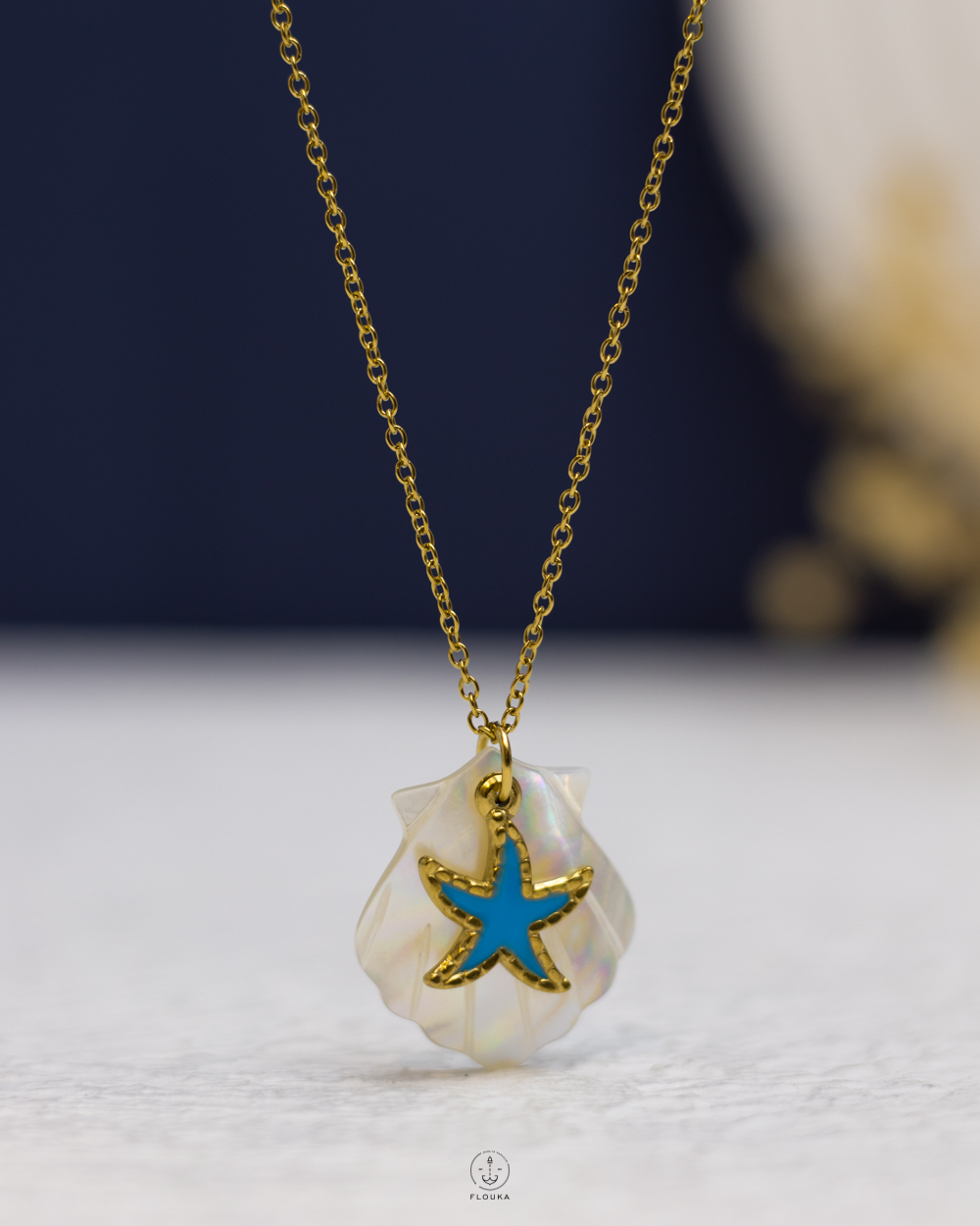 1758673290_n1875.jpg white rasin seashell & blue seastar gold necklace