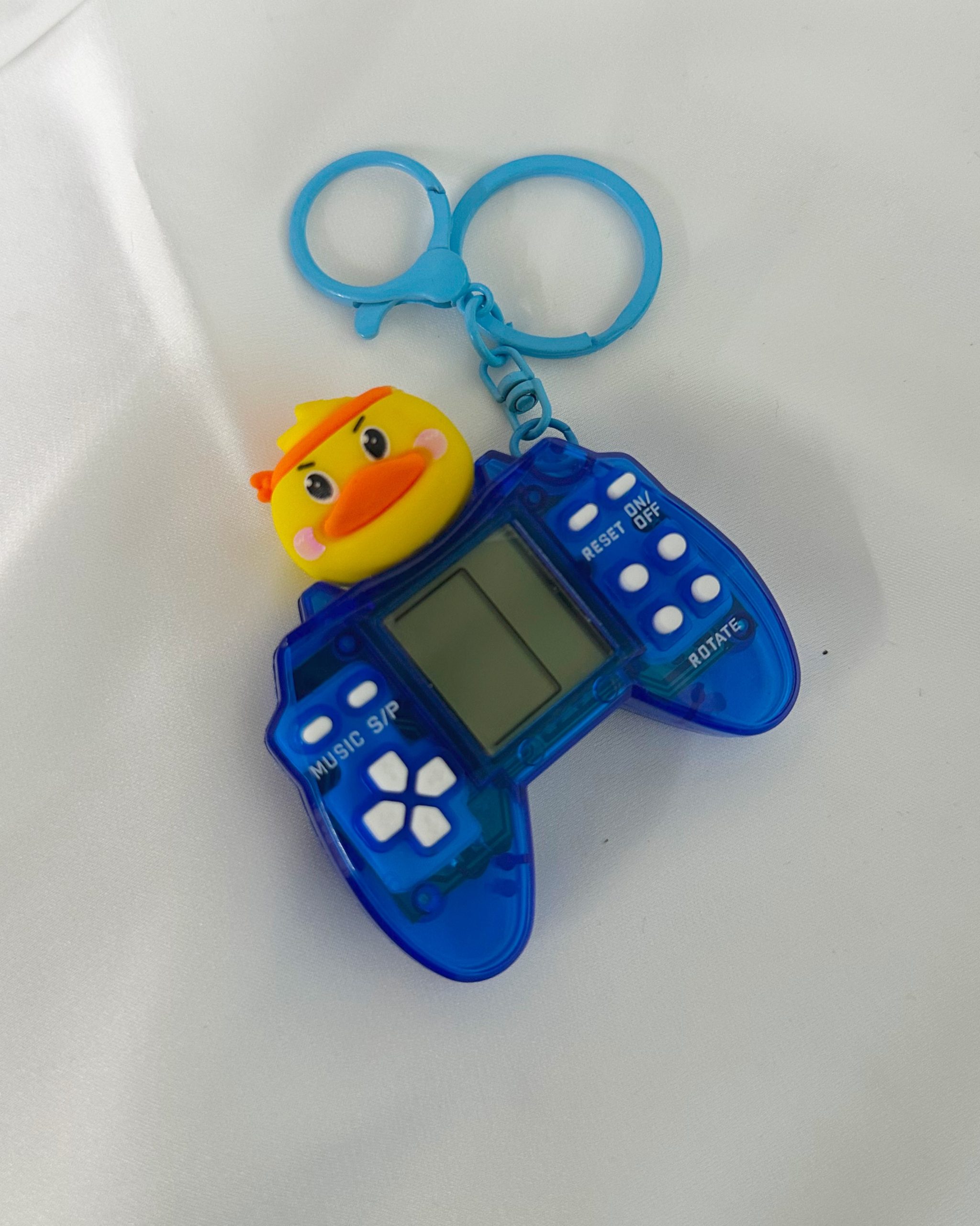 1759879465_photo-output.jpeg blue game console keychain