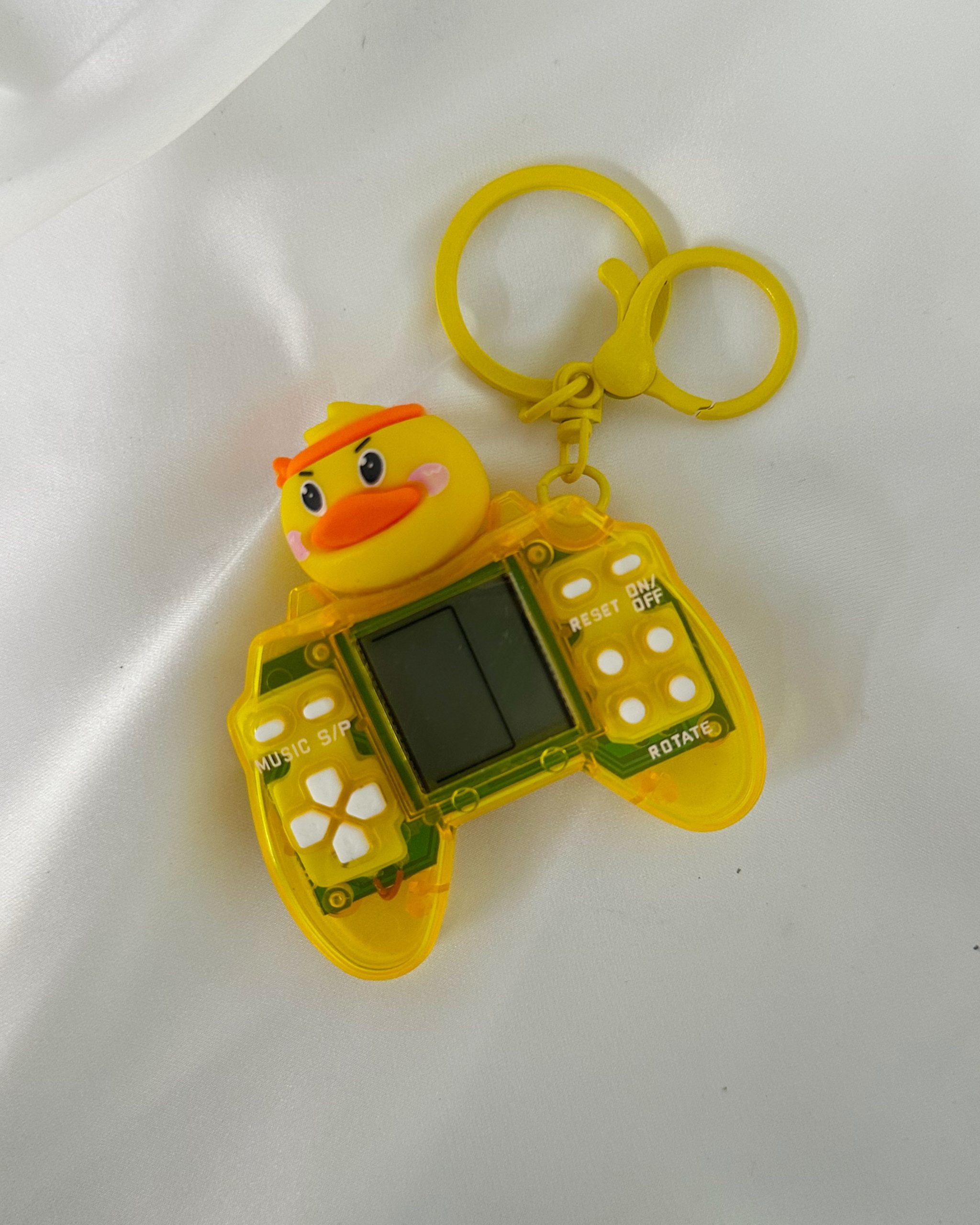 1759879521_photo-output.jpeg yellow game console keychain